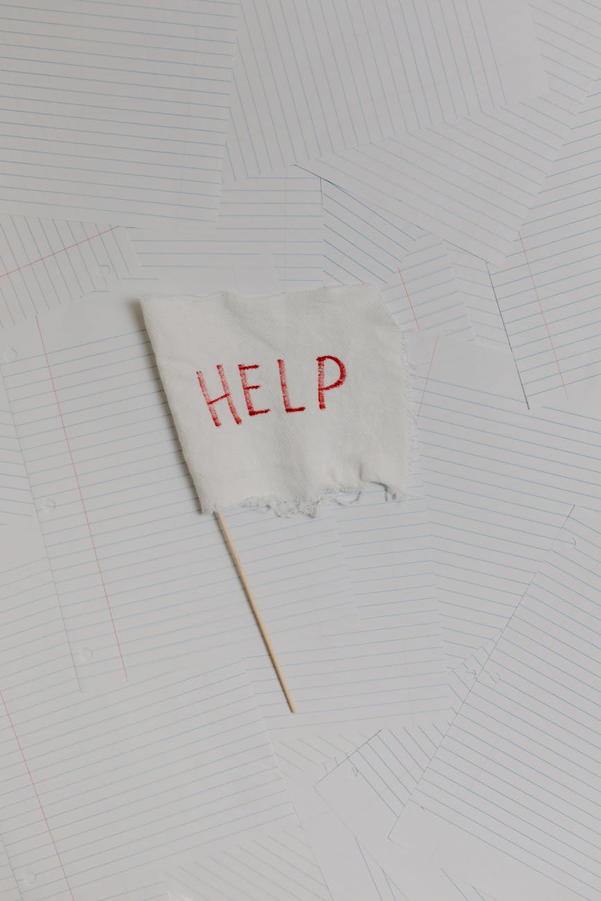 overhead shot of the word help written on a small flag